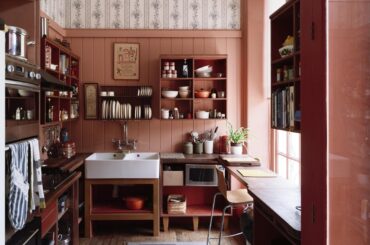 Kitchen with V-groove panelling painted in a warm salmon shade in an 18th-century country house in a rural estate, Kent, England [1600x1067]