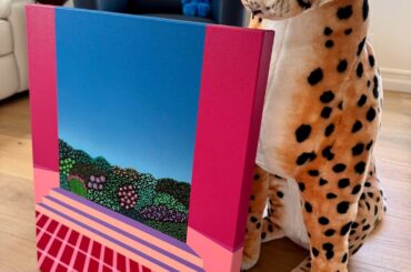 My pet cheetah in our living room standing next to my newest painting