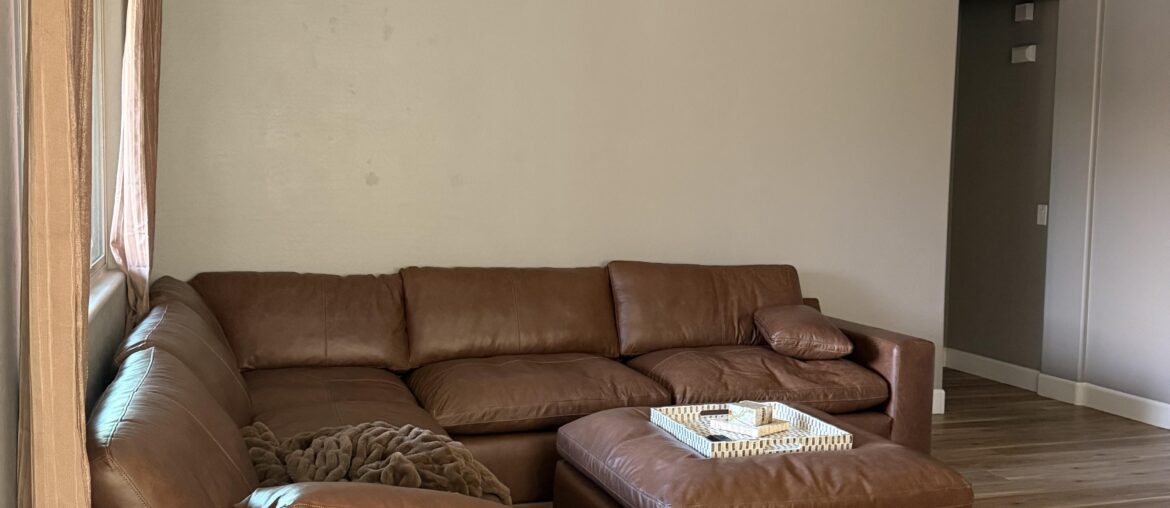 What do I put on this wall the couch is 11 ft for reference and I have a rug coming in that is cream patterned and I’ll eventually replace the curtains