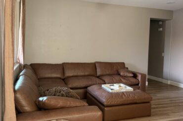 What do I put on this wall the couch is 11 ft for reference and I have a rug coming in that is cream patterned and I’ll eventually replace the curtains