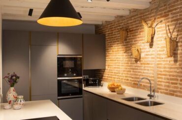 kitchen with exposed brick and sculptural lighting in a restored apartment, Barcelona Spain [640x899]