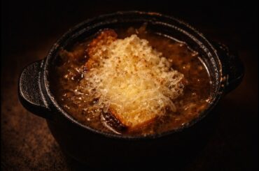 French Onion Soup Over Fire on a Cold Rainy Evening