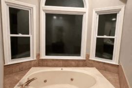 How are curtains supposed to be hung for privacy in this bathroom?