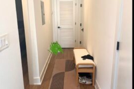 Which side for entry bench, pic 1 or 2? Front door is the door to the right. Door straight ahead with slats is unused utility closet.