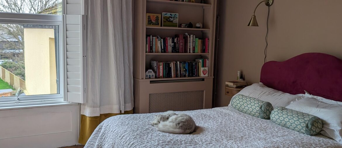 Having fun with textiles! Headboard, curtain and bedskirt by me. Cat: model's own