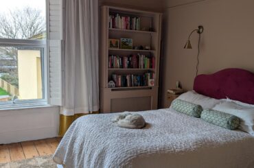 Having fun with textiles! Headboard, curtain and bedskirt by me. Cat: model's own