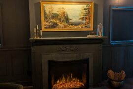 How does my mantle decor look? This is a basement area that has a dark academia/moody English traditional feel. Side note, I'm going to install the painting light lower than where it currently is.