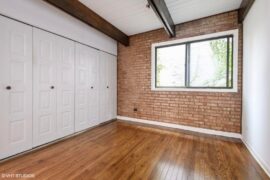 Which color desk would suit this room better?