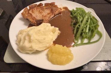 Pork chop with mash, runner beans and gravy with homemade apple sauce