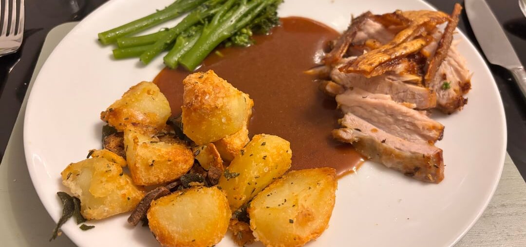 Pork belly, roasties with garlic sage and rosemary, broccoli and gravy