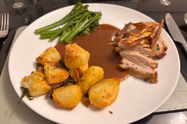 Pork belly, roasties with garlic sage and rosemary, broccoli and gravy