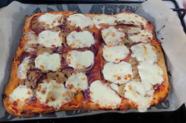 Homemade pizza with tomato sauce,mozzarella, tuna, onions, mortadella and mushrooms 😋