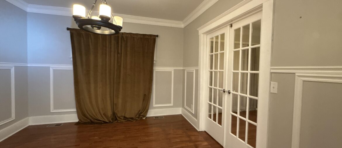 I am trying to figure out how to paint this dining room. I was leaning towards a darker color, and am wondering if I should paint over all of the wainscoting or leave it white or cream.