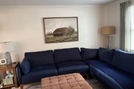 I hate my family room. The first pic is what it is currently, second pic is what it WAS. Next pics are views from the couch and last two are AI designs. Please help me. It feels cold and stark. I like warm cozy traditional, open to modern as well.