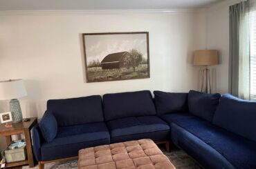 I hate my family room. The first pic is what it is currently, second pic is what it WAS. Next pics are views from the couch and last two are AI designs. Please help me. It feels cold and stark. I like warm cozy traditional, open to modern as well.