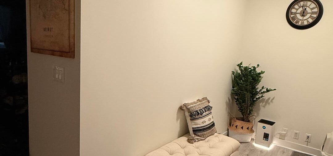 What artwork would you put above the ottoman in my den area?