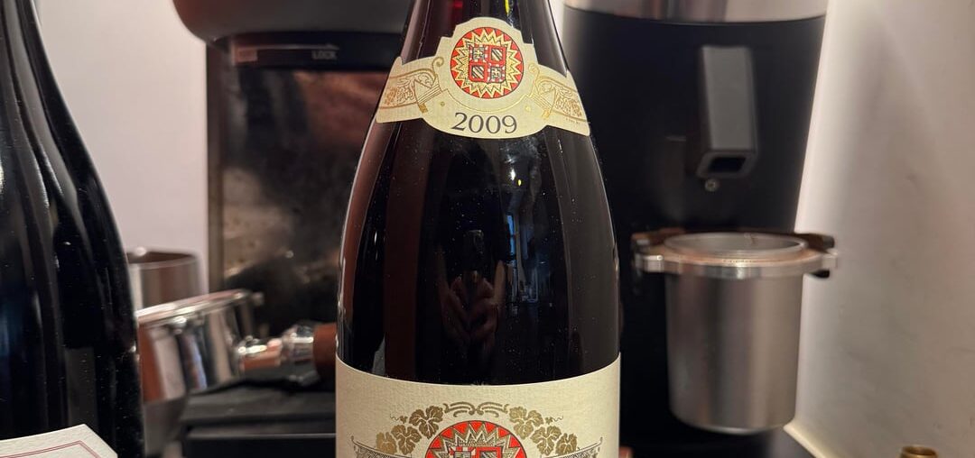 Floating grape-skin like object in bottle Floating grape-skin like object in bottle