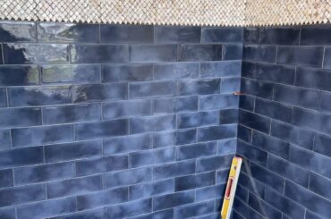 What navy blue paint color would match with our tiles? Please include the brand