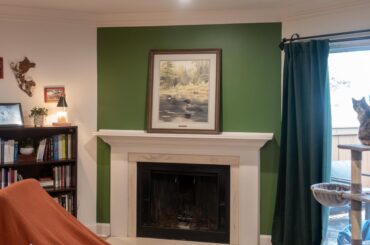 Decorating around big painting on mantle