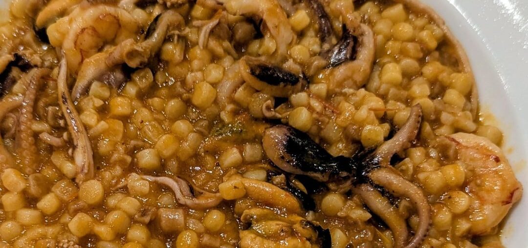 Fregula (a semolina pasta from Sardinia) with seafood and seada (a fried pastry from Sardinia filled with pecorino cheese and drizzled with honey)