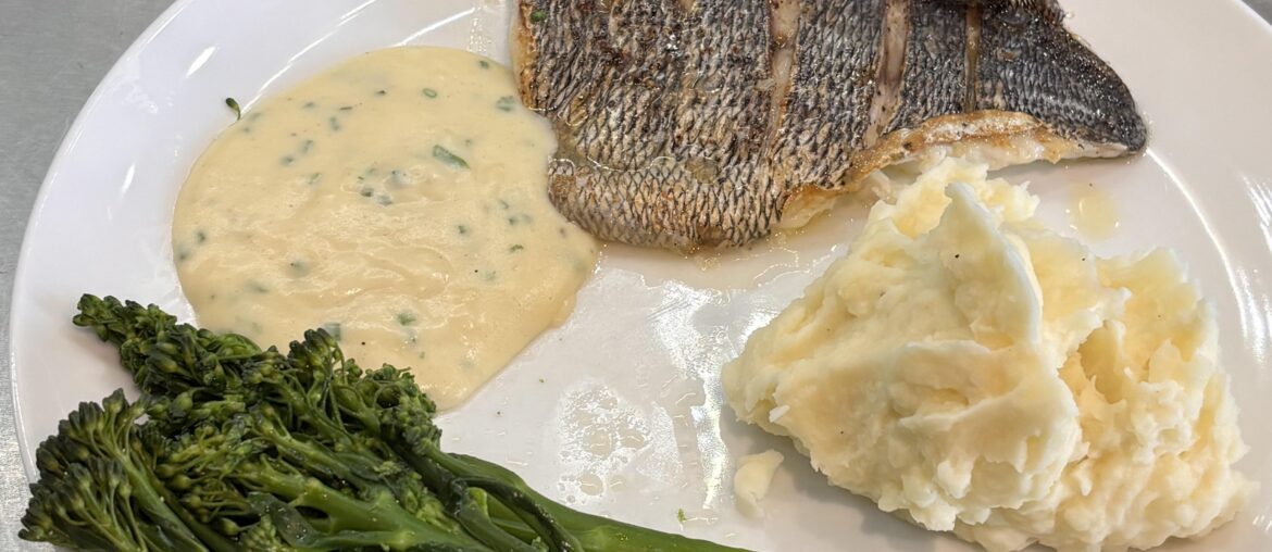 Black Bream, mash, broccoli and white sauce with chopped chives