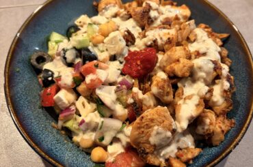 Greek salad with chickpeas, Middle Eastern spiced chicken, tahini sauce and spicy pepper paste