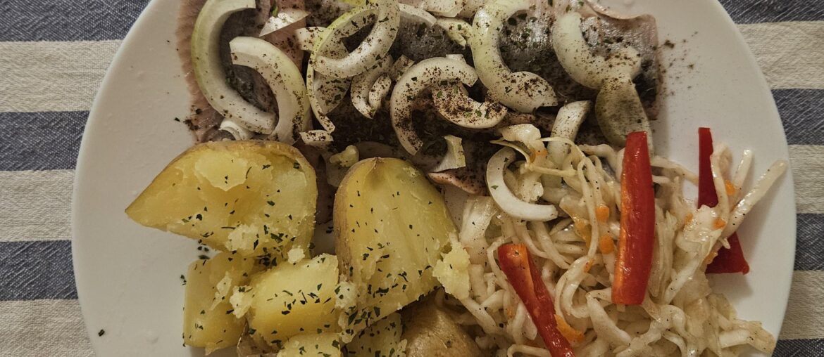 Herrings with onions, potatoes and cabbage salad