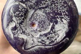 Second hand bottle has (needle?) hole in the wax