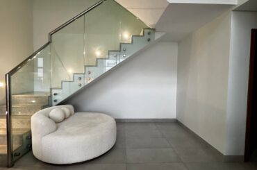 How would you transform this awkward under-stairs space into something warm and inviting?