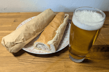 Baguette with a good ham, Grana Padano, rucola and iceberg salad in vinaigrette