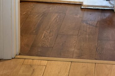 Is it aesthetically acceptable to have different wood stain for bedrooms and living room/hallway in an apartment?