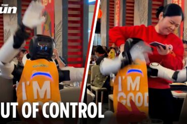 Out of control robot smashes up restaurant as waitress desperately attempts to drag it away