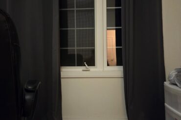 Can I place a tv and tv stand with a window behind it?