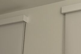 How the heck do I hang curtain rods over these wide mounted blinds?