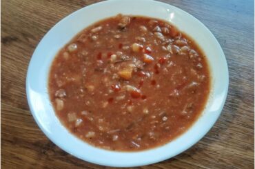 Borscht with a little chili sauce and fried potato dumplings with peppers, sausage, green onions and spicy dip 😋