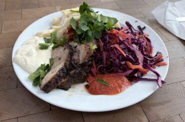 Jerk-marinated pork, mac & cheese, salad and condiments
