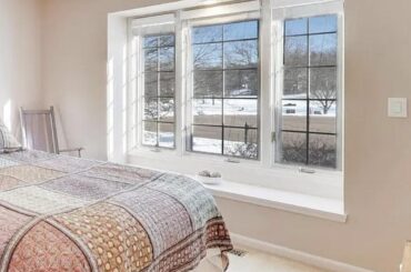 Where should I hang blackout curtains for this window that has a small bench? And how long should they be?