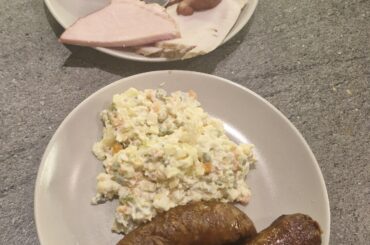 Easter supper-roasted white sausage, vegetable salad and different ham variations