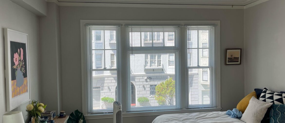 Best way to hag curtains on a long concrete wall (no drilling)