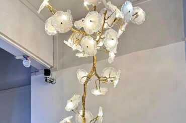 What small wall lights/scones would you add to an upstairs hallway (located right at the end of the stairs) if this chandelier is hanging around the staircase?