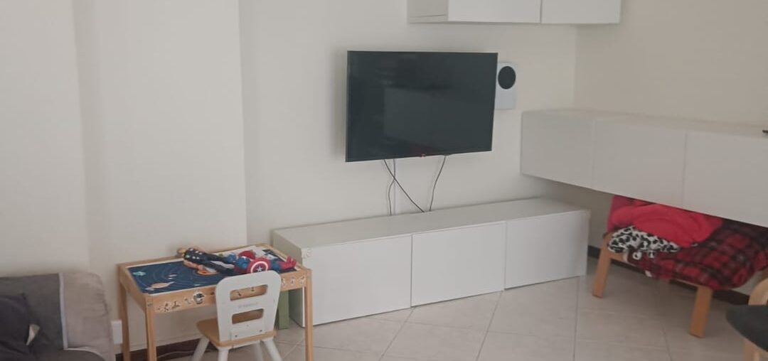 Modernizing an apartment with light floors and walnut windows