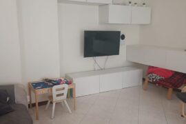 Modernizing an apartment with light floors and walnut windows