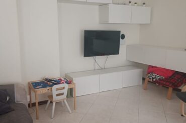 Modernizing an apartment with light floors and walnut windows