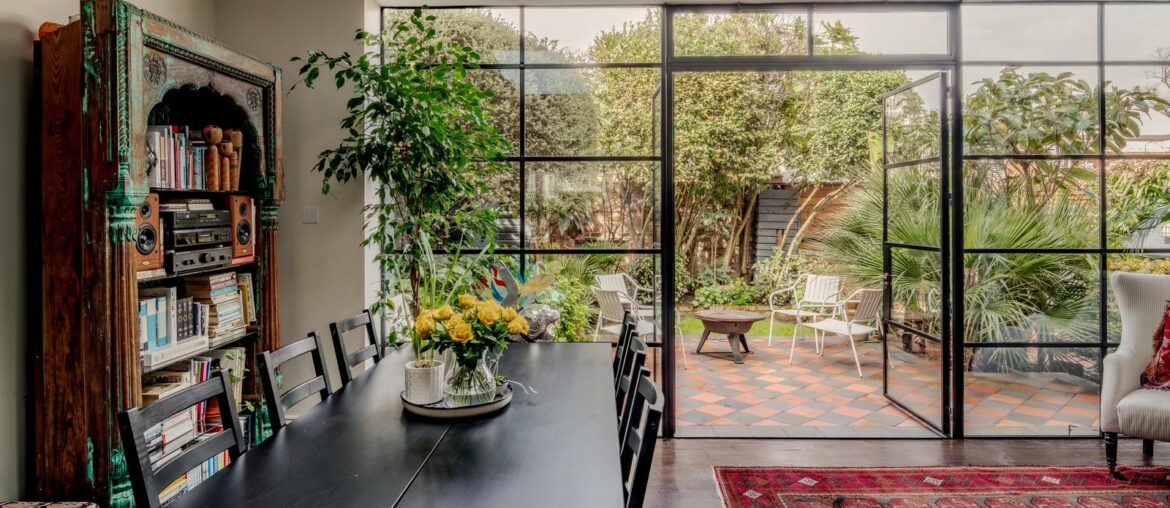 Living and dining space opening up to the patio garden in a renovated 19th-century house, Cheltenham, Gloucestershire, England [1600x1067]