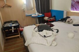 Hotel room got a bed and vibes… where’s the rest of the furniture? 😭