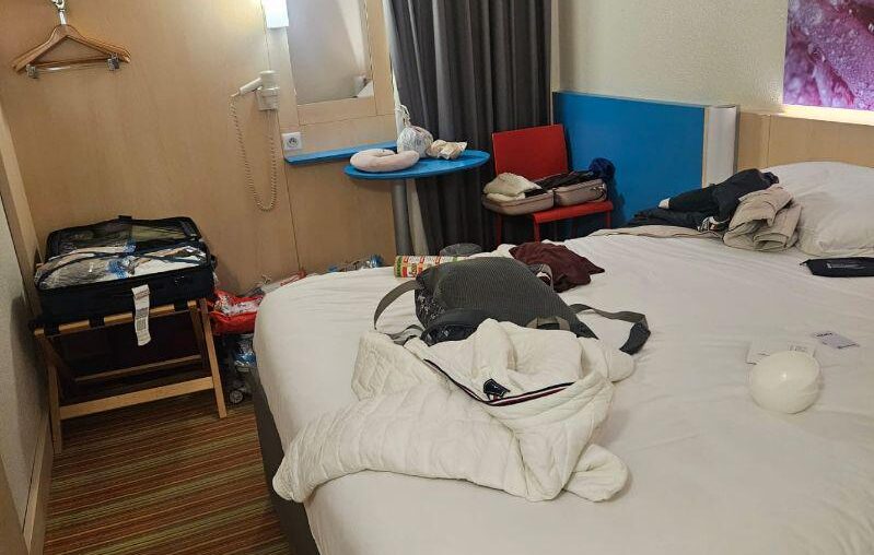 Hotel room got a bed and vibes… where’s the rest of the furniture? 😭