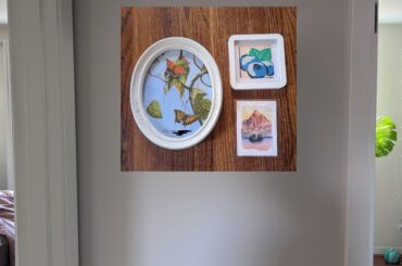 Help! How does this art collage look in this small hallway? How to improve/framing advice? Tia!