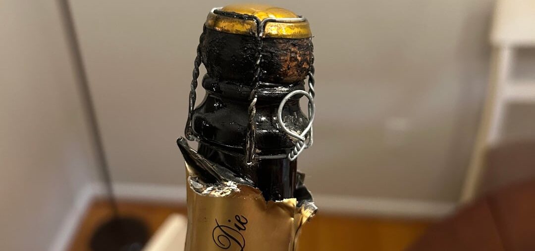 I’m new to wine, what is this black oil covering the cork? Is it intentional