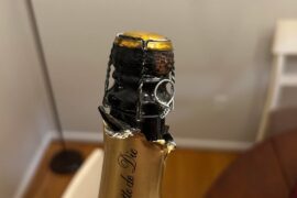 I’m new to wine, what is this black oil covering the cork? Is it intentional