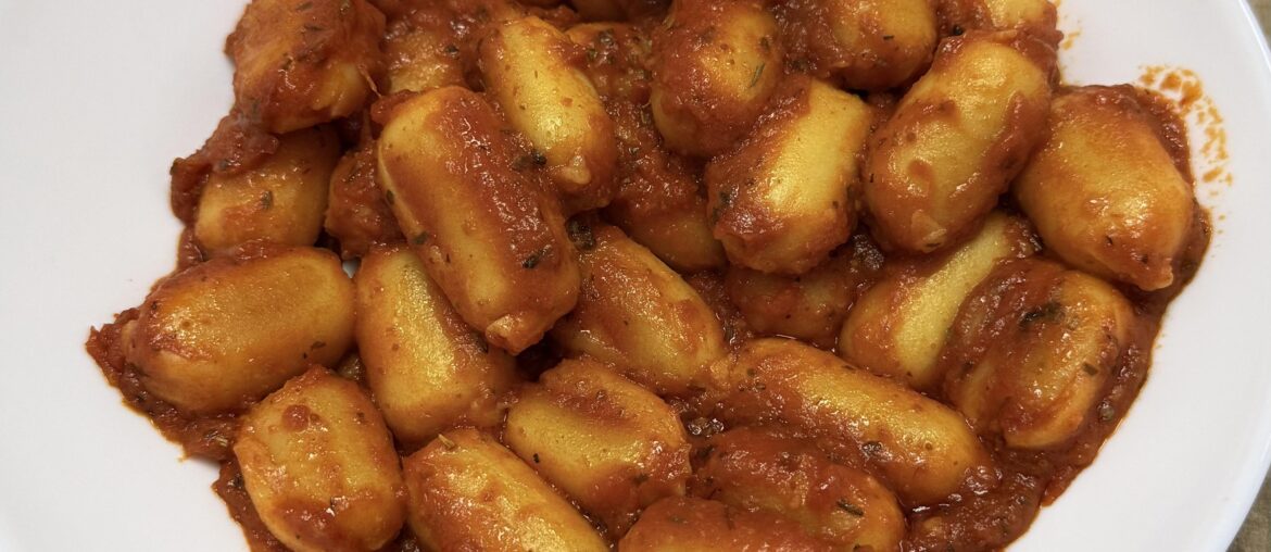 Cheese filled gnocchis, tomato sauce with pecorino and Italian herbs